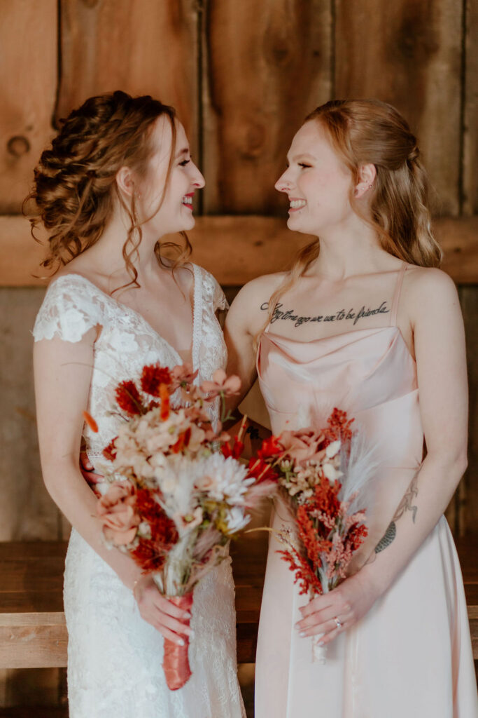 bride with her bridesmaid holding fall wedding bouquets