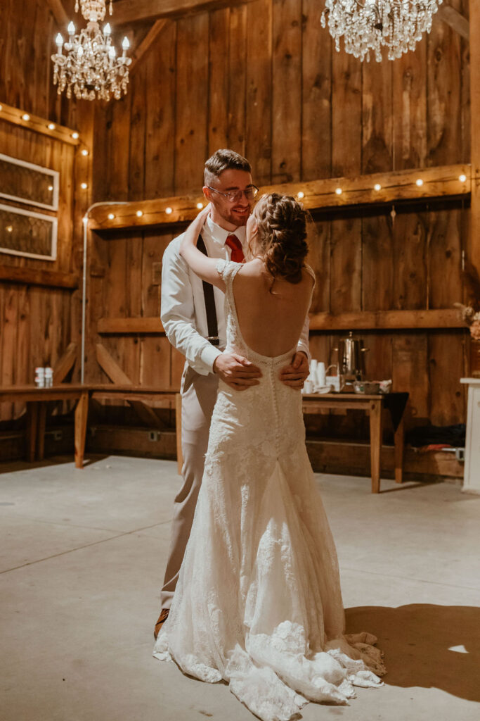 bride and groom first dance in barn wedding venue